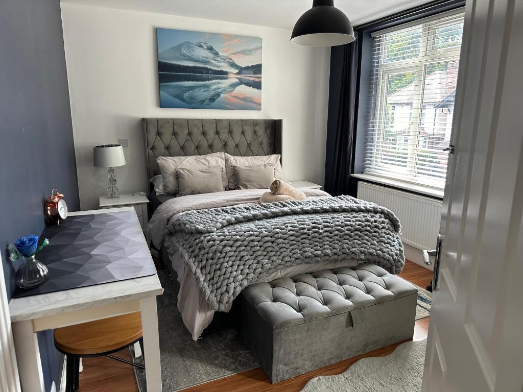 a bedroom with a bed with a teddy bear on it at Lux Akinle Residence in Nottingham
