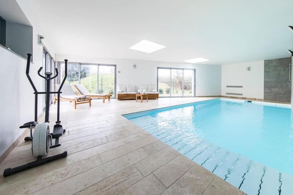 a swimming pool in a house with a gym at La Villa Atea in Joue-les-Tours