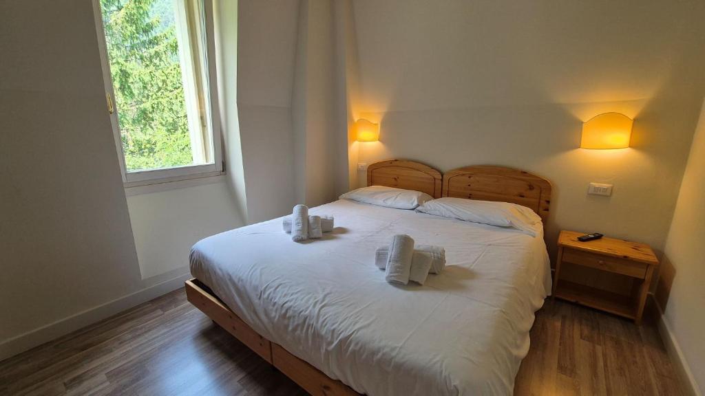 Postel nebo postele na pokoji v ubytování Hotel Saisera