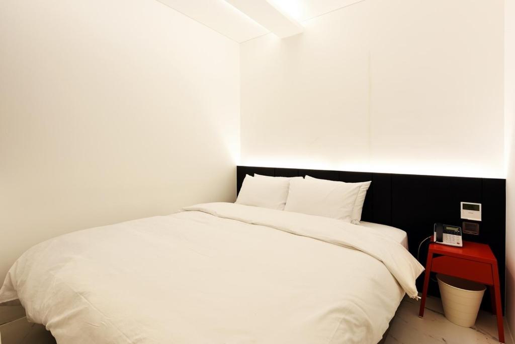 Postel nebo postele na pokoji v ubytování Hotel Infini