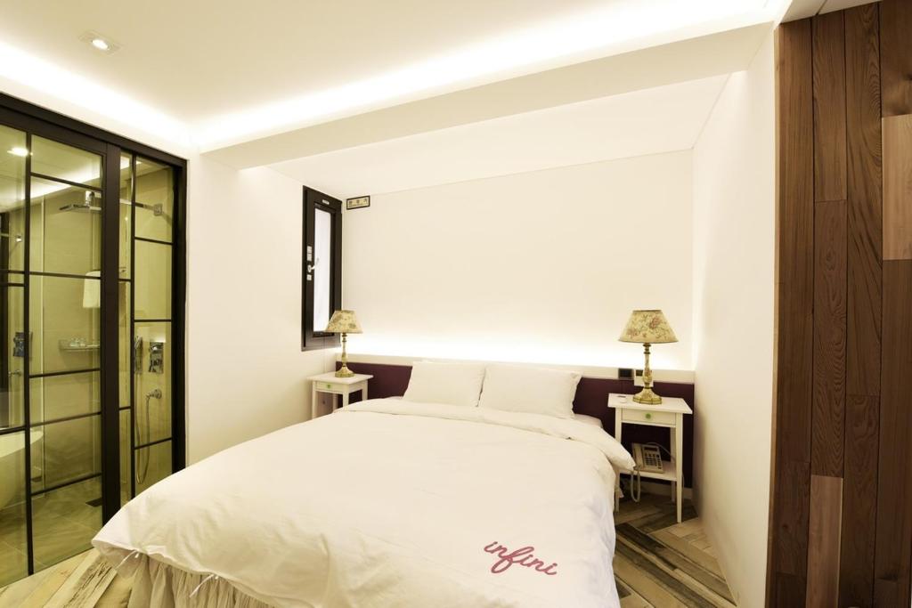 Postel nebo postele na pokoji v ubytování Hotel Infini