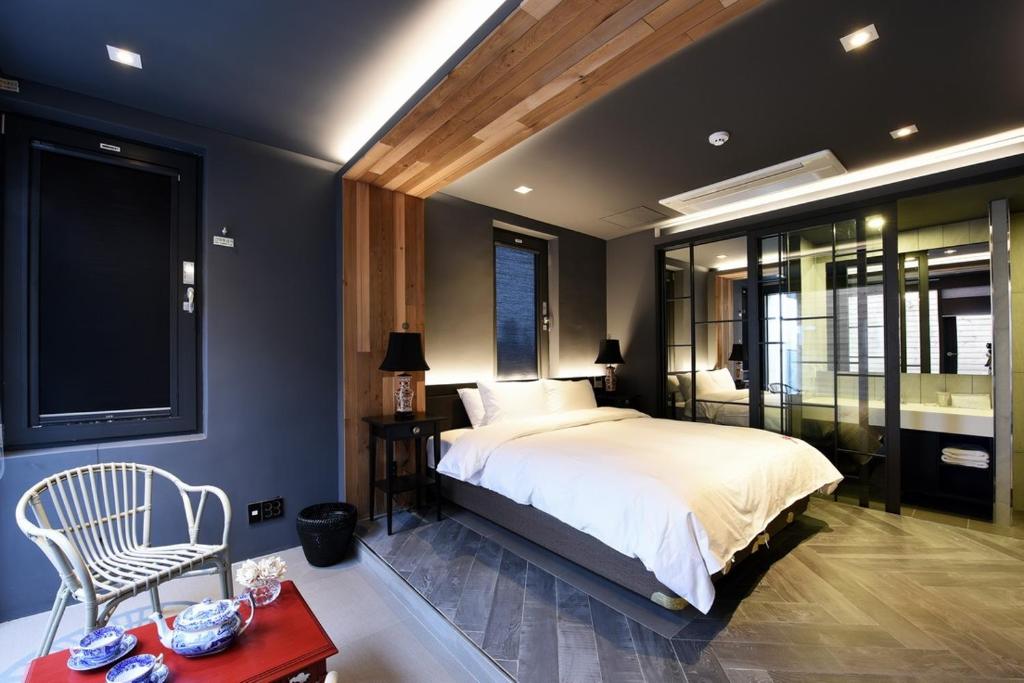 a bedroom with a large bed and a tv at Hotel Infini in Seoul