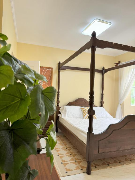 a bedroom with a bed with a lamp on it at Cajigal Farmhouse - high speed converge internet and AC in 2 bedrooms in Badoc