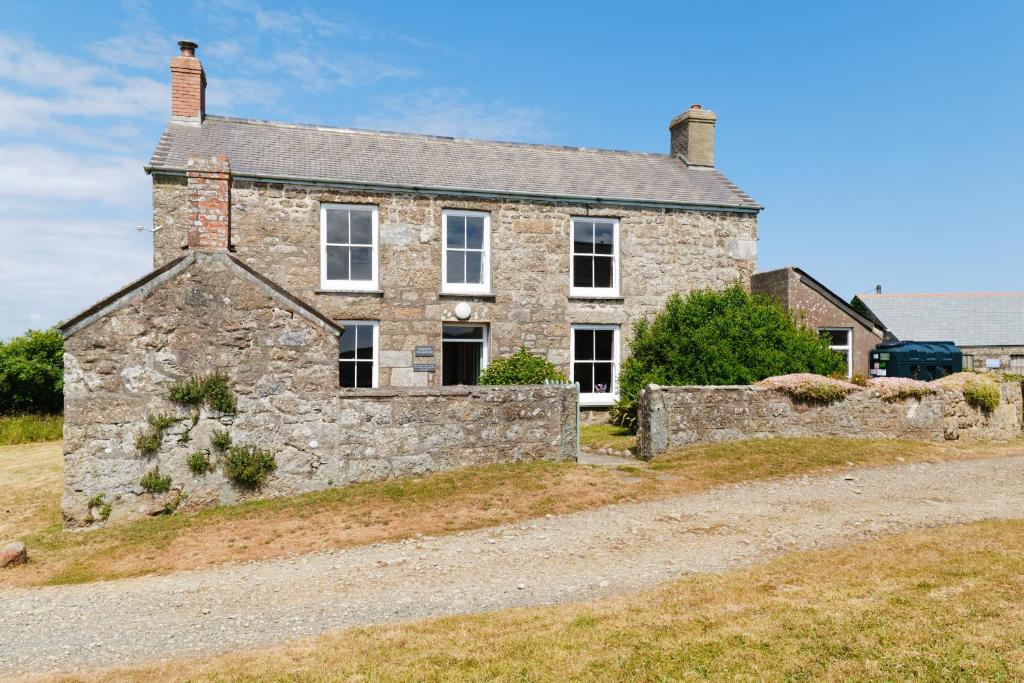 an old stone house on the side of a road at Bosistow Farmhouse in Penzance