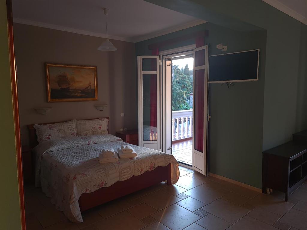 a bedroom with a bed and a sliding glass door at Edem Studios in Syvota