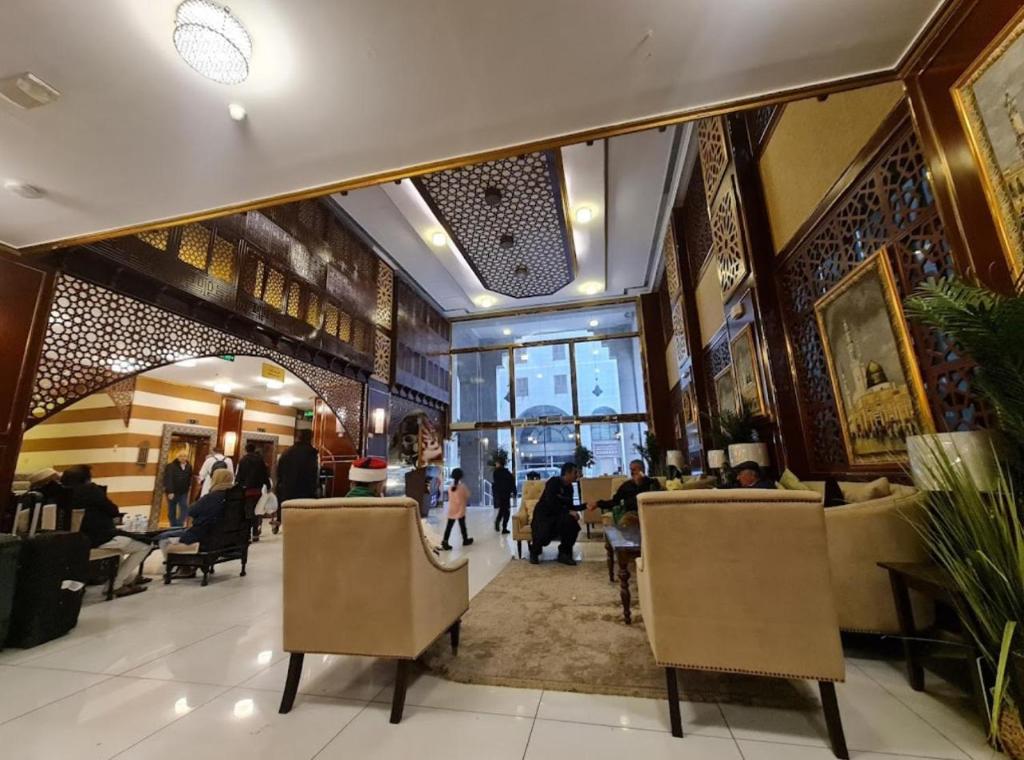 a lobby with chairs and people in a building at فندق منازل المرسى Manazil almarsa in Al Madinah