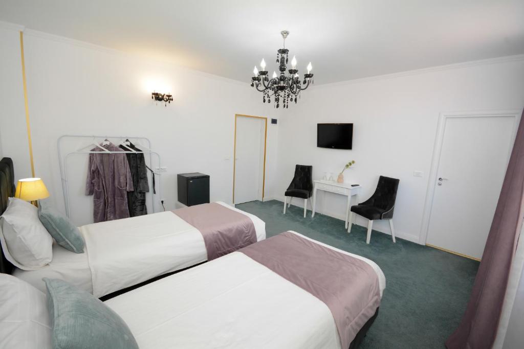 Postel nebo postele na pokoji v ubytování Hotel Andre´s