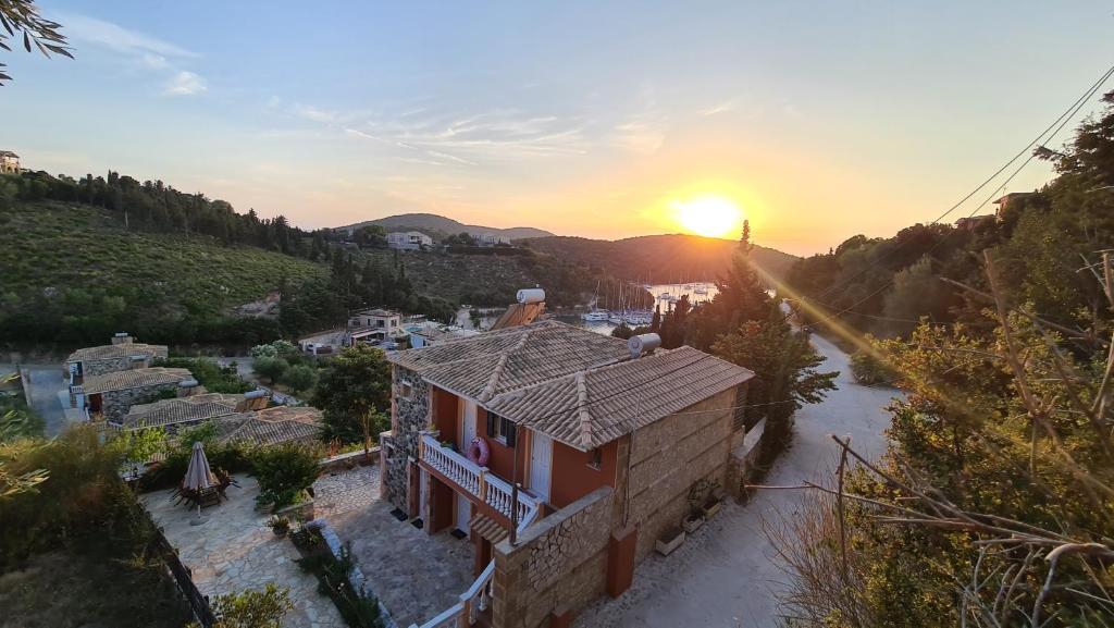 an aerial view of a house with the sunset in the background at Edem Studios in Syvota