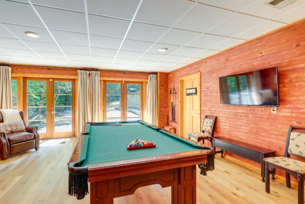 a room with a pool table and a tv at Hot Tub, Decks and Creek Access McCaysville Cabin! in McCaysville