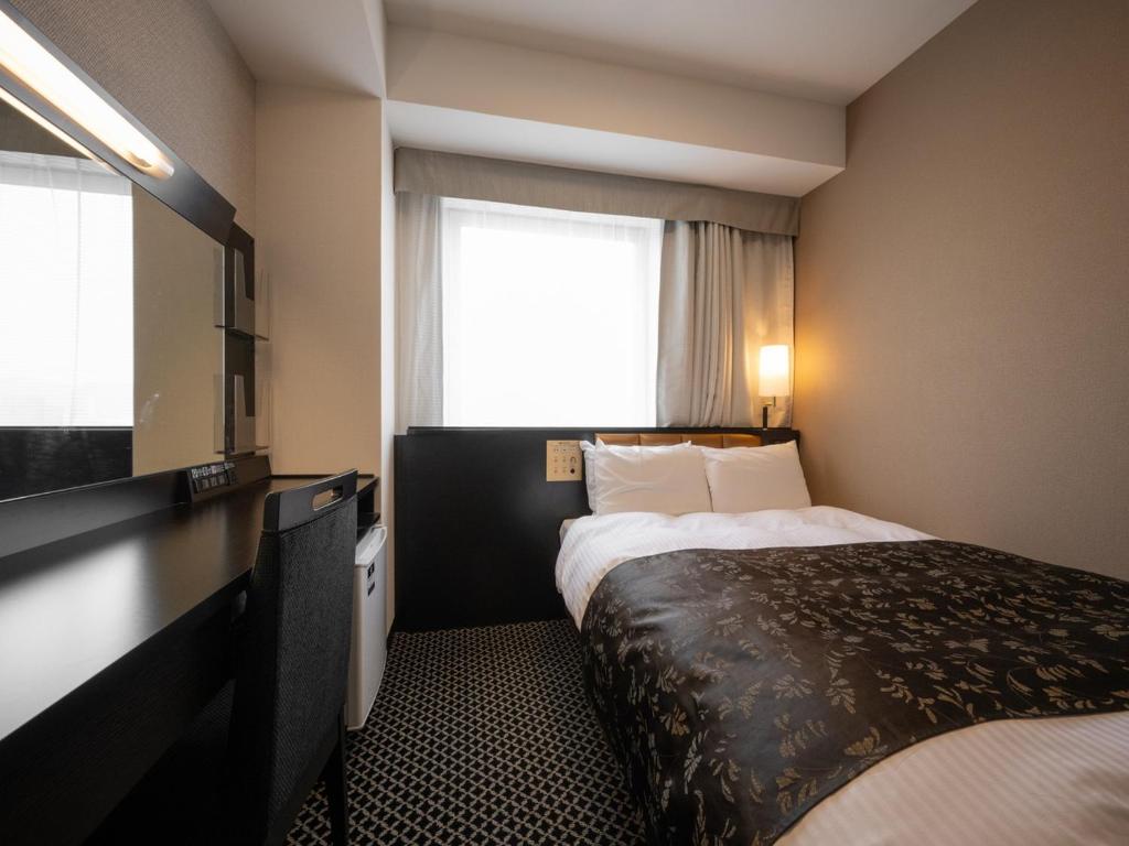 Postel nebo postele na pokoji v ubytování APA Hotel Fukui Katamachi