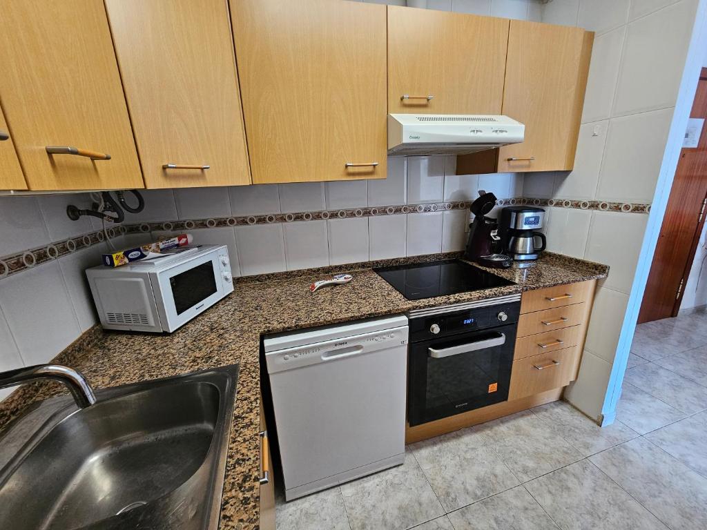 Kuchyň nebo kuchyňský kout v ubytování Appartement tout confort terrasse 21 m2 pleins sud wifi proche port aventura centre et plage 2 chambres 2 SDB piscine