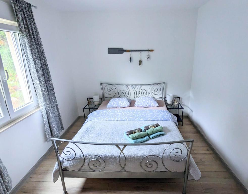 a bedroom with a bed with two pillows on it at Apartment Sea Garden in Ičići