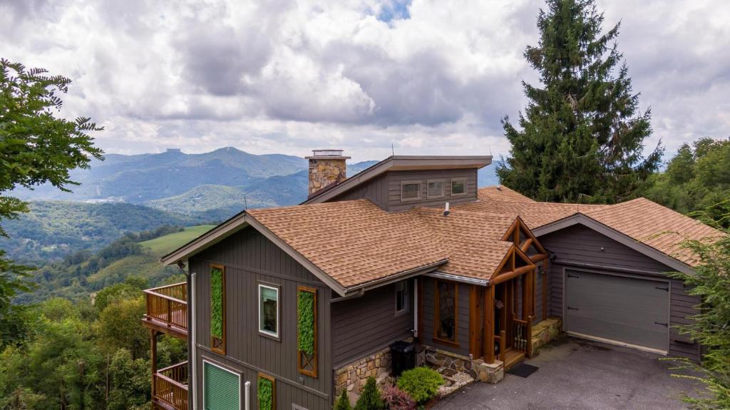 a house with a garage and mountains in the background at Grandview Haven in Banner Elk