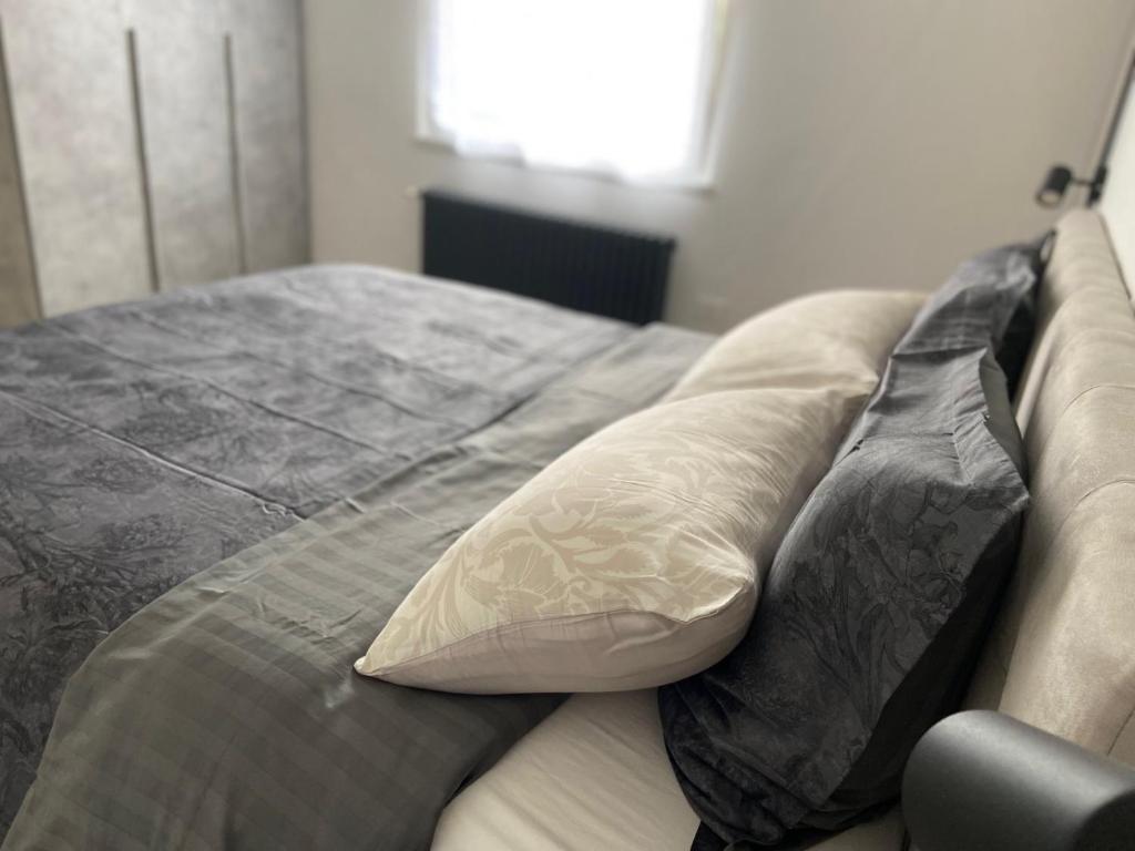a bed with two pillows on top of it at Luis Home in Laives