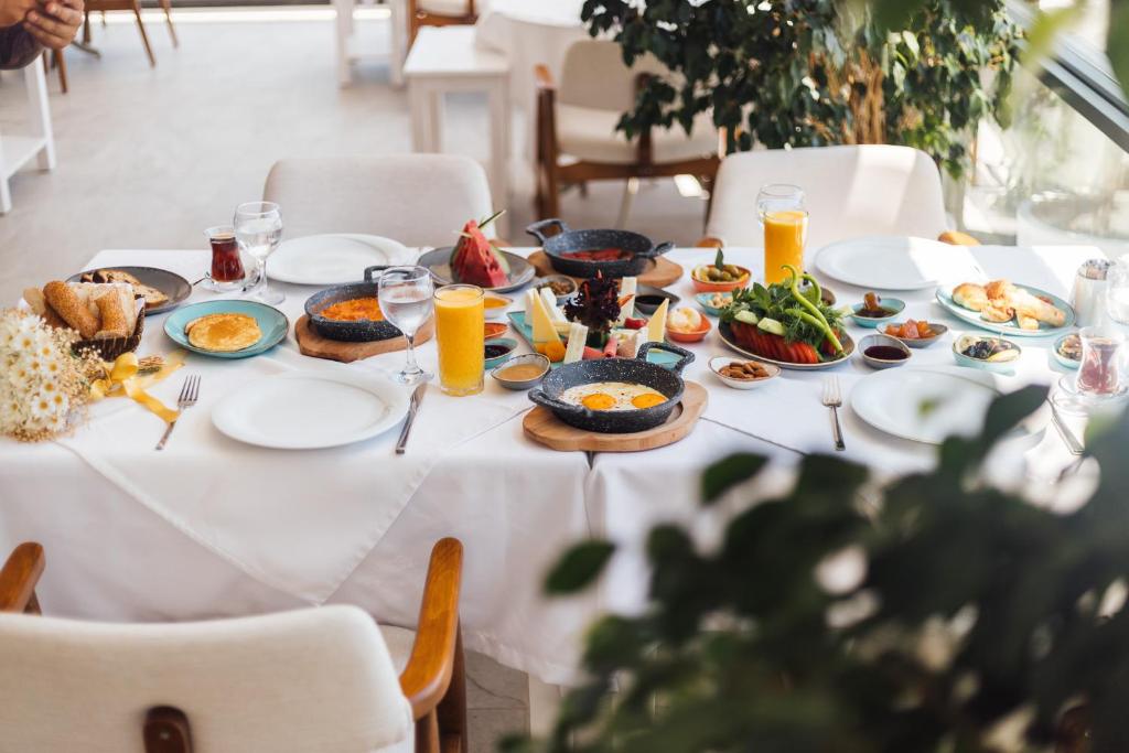 a white table with plates of food on it at La Kumsal Hotel in Kaş