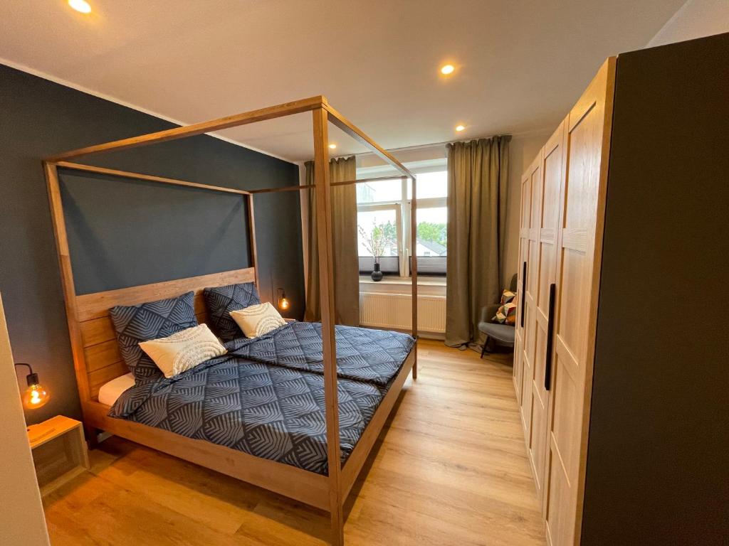 a bedroom with a canopy bed in a room at Moderne Wohnung - renoviert 2024 in Solingen