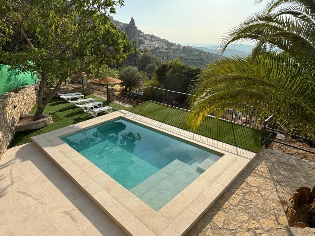 a swimming pool with a view of a mountain at Casa Loarre in La Iruela