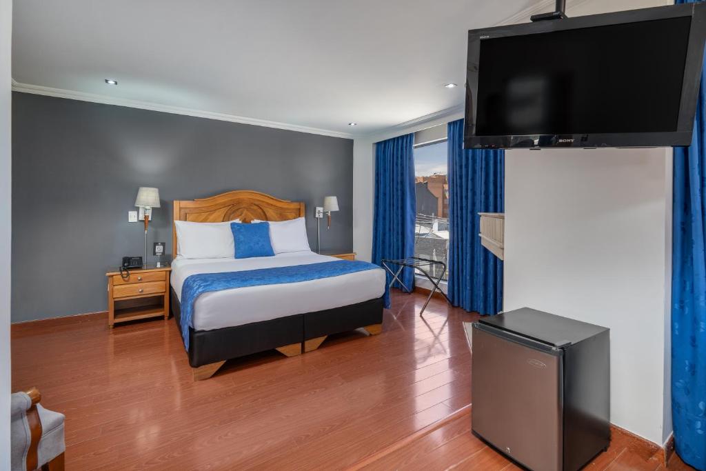 Postel nebo postele na pokoji v ubytování Hotel Egina Bogotá