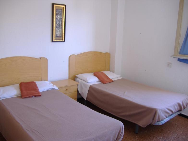 two beds in a room with at Hostal Casa de Huéspedes San Fernando - Adults Only in Playa del Ingles