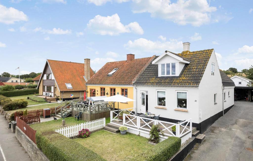 a large white house with a white fence at Beautiful Home In Allinge With Kitchen in Allinge