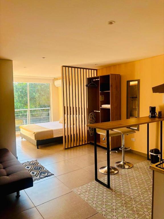 a living room with a table and a bed at Hotel Payara Puerto Gaitán in Puerto Gaitán