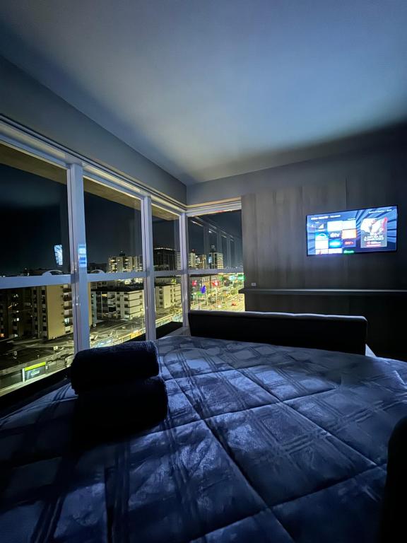 a living room with a view of a city at night at Loft, Próximo ao Consulado EUA in Porto Alegre