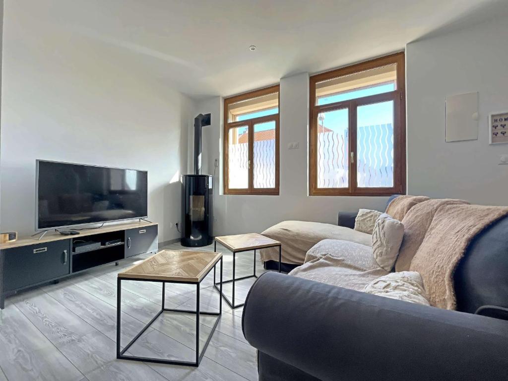 un soggiorno con divano e TV a schermo piatto di Maison entre ville et plage avec cour jardin - FR-1-646-78 a Berck-sur-Mer