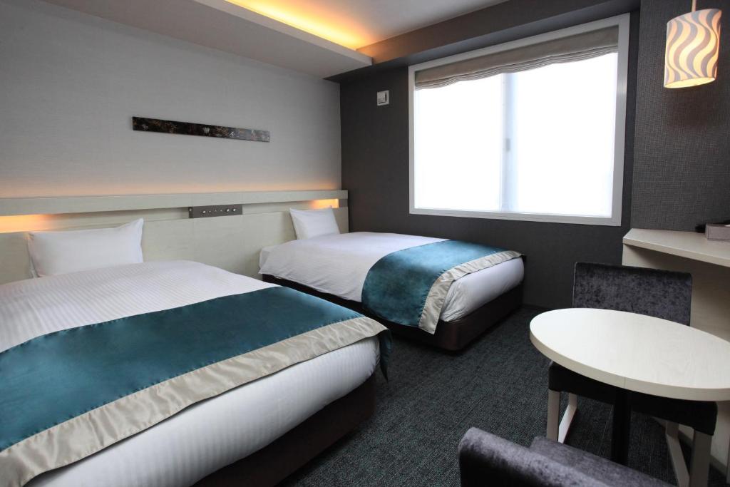 Postel nebo postele na pokoji v ubytování Urban Hotel Kyoto Shijo Premium