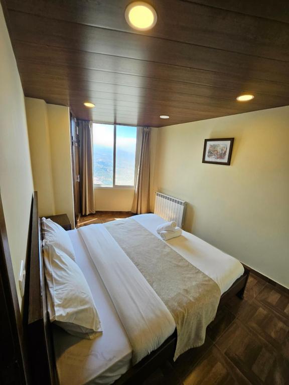 Postel nebo postele na pokoji v ubytování Hotel L'Aiglon