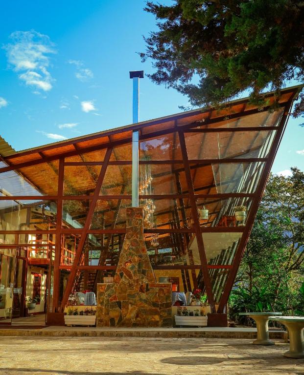 a large building with a large glass facade at Ecoterra Inka Lodge Shared Rooms in Quillabamba