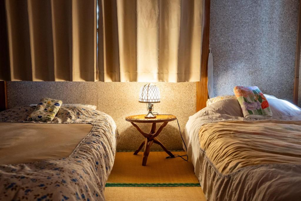 Postel nebo postele na pokoji v ubytování Rishiri Antique Inn