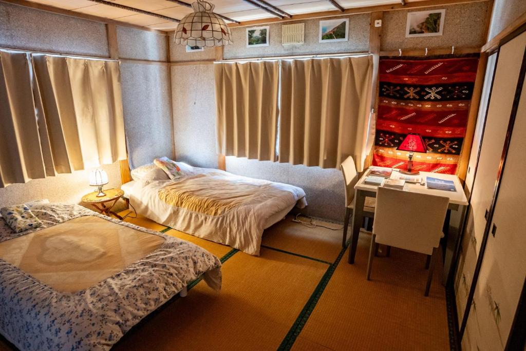 Postel nebo postele na pokoji v ubytování Rishiri Antique Inn