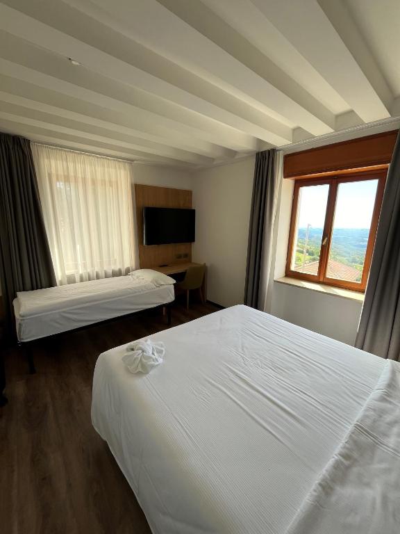 Postel nebo postele na pokoji v ubytování Hotel Belvedere