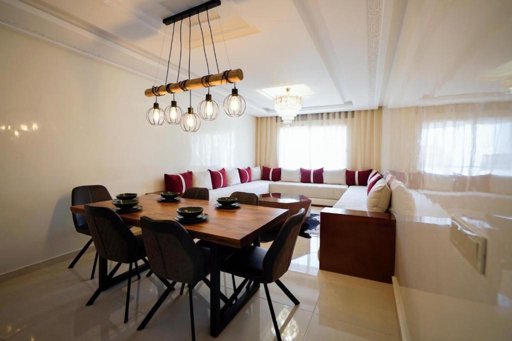 un soggiorno con un tavolo e un divano di Appartement in Tanger City-5min to the Beach-free Parking a Tangeri