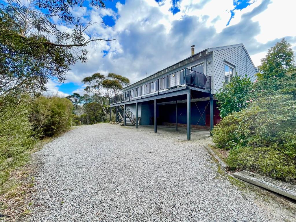 a house with a balcony on the side of it at Treetops Retreat Katoomba in Katoomba