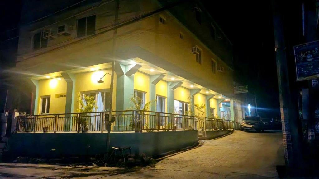 a building with lights on the side of it at night at Drossgold Pension House in Tubigon