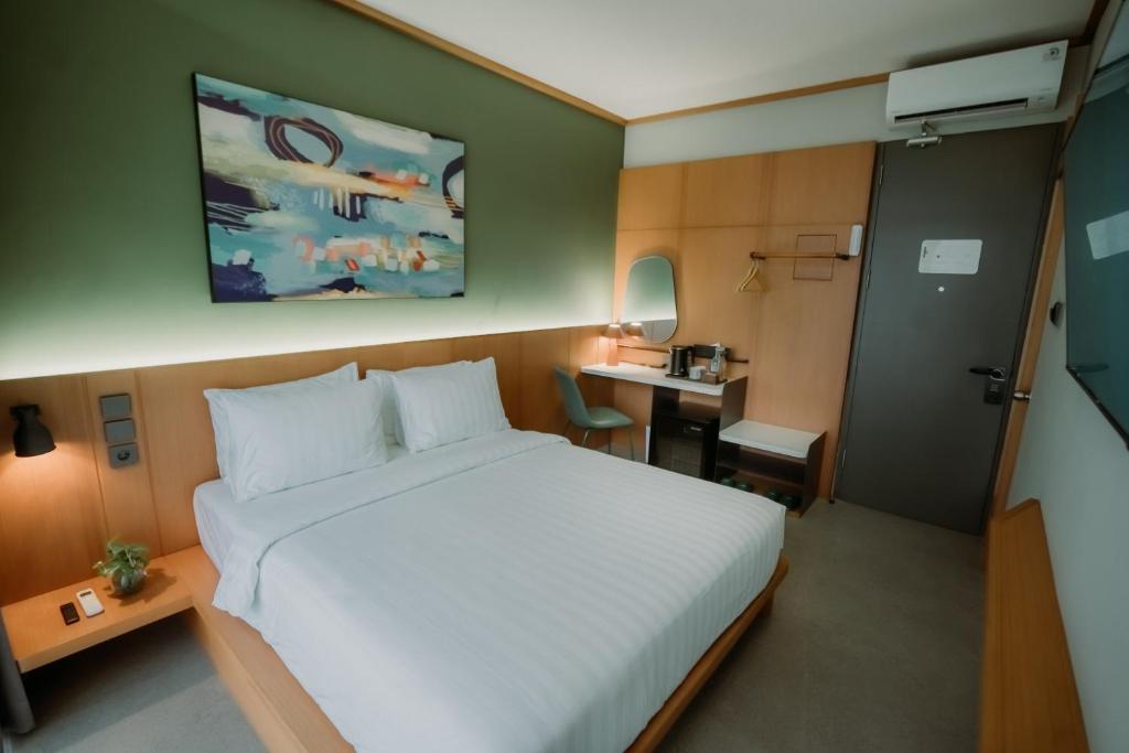 Postel nebo postele na pokoji v ubytování Jiro Hotel