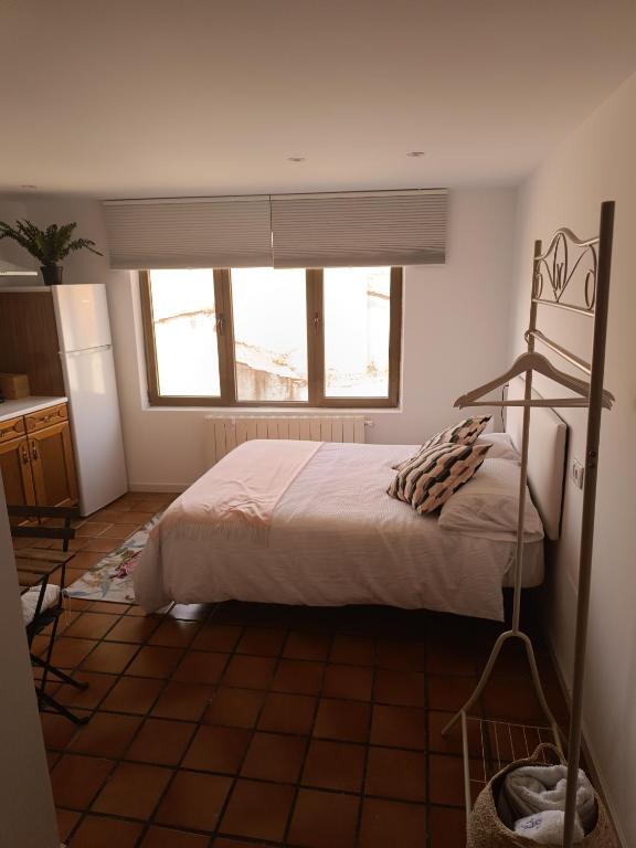 a bedroom with a large bed and a window at Casa de la tía 2 in Simancas