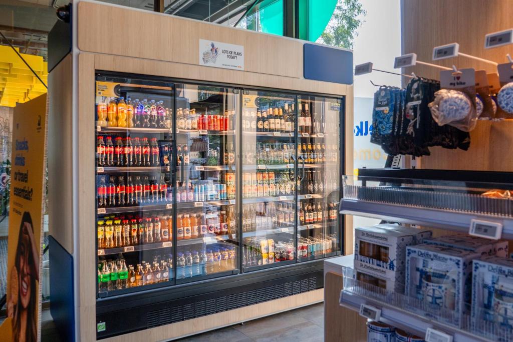 a cooler in a store filled with lots of drinks at MEININGER Hotel Amsterdam City West in Amsterdam