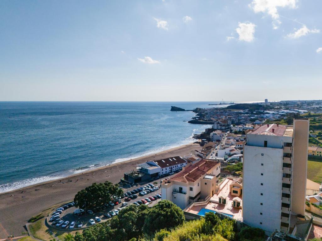 an aerial view of a beach with a building at Regatta - Beachfront and Sea Views in Ponta Delgada