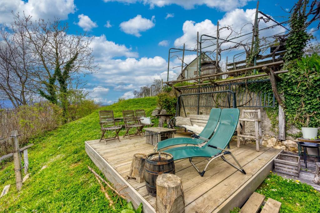 a blue chair sitting on a wooden deck at Vineyard Cottage Verček - Happy Rentals in Novo Mesto