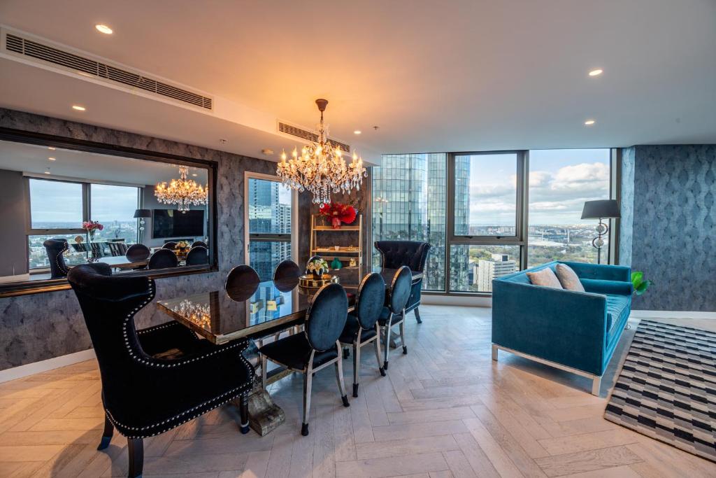 a dining room with a chandelier and a table and chairs at Premium Luxury Sub-Penthouse in Melbourne