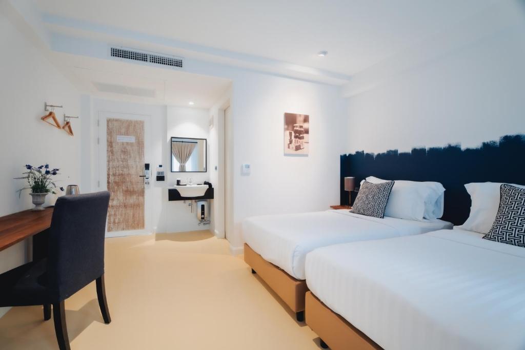 Een bed of bedden in een kamer bij Xinlor House - Phuket Old Town