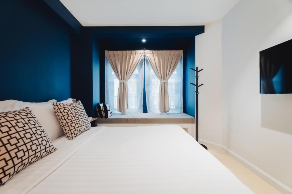 Een bed of bedden in een kamer bij Xinlor House - Phuket Old Town