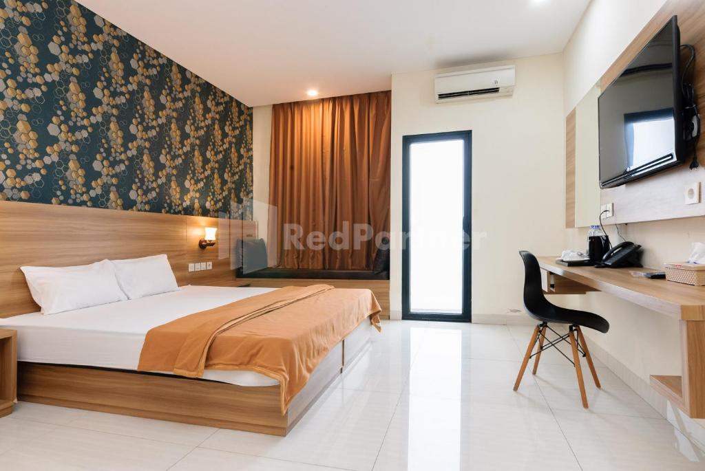 โทรทัศน์และ/หรือระบบความบันเทิงของ Deluma Hotel Syariah RedPartner