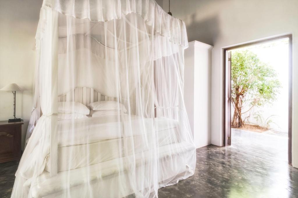 Postel nebo postele na pokoji v ubytování Nisala Arana Boutique Hotel