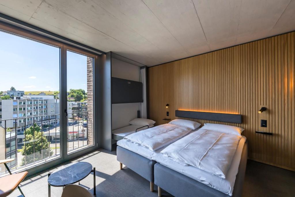 Postel nebo postele na pokoji v ubytování Zleep Hotel Zürich-Kloten