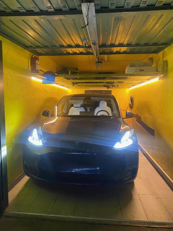 a car parked in a garage with its roof open at Casa Giacomo in Arona
