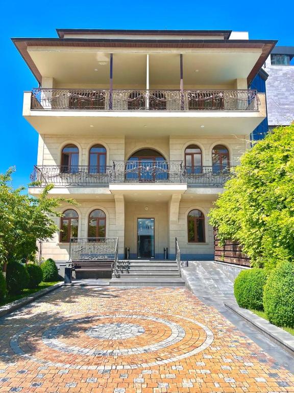 a large building with a balcony on top of it at Bien hotel in Yerevan