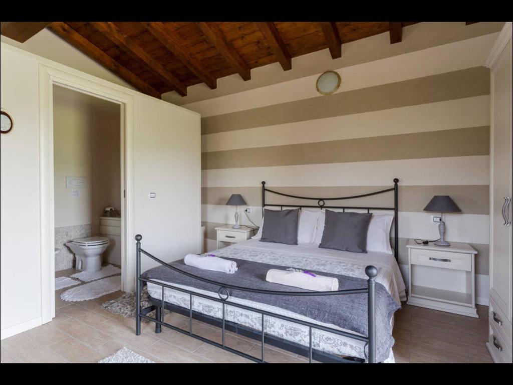 Postel nebo postele na pokoji v ubytování B&B Ronco degli Ulivi